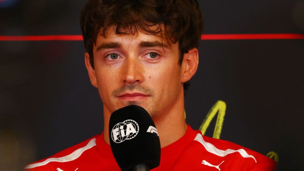 Charles Leclerc wearing his red Ferrari race suit in the paddock ahead of the Monaco Grand Prix