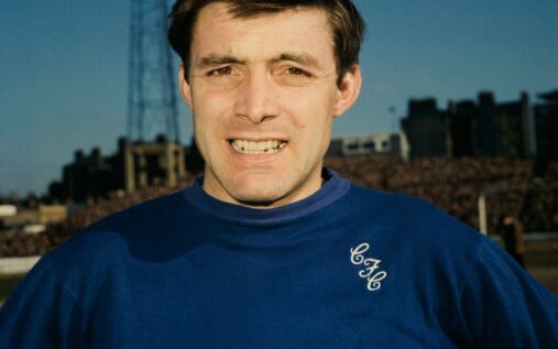 Bobby Tambling smiling in a retro blue Chelsea football kit during his playing career