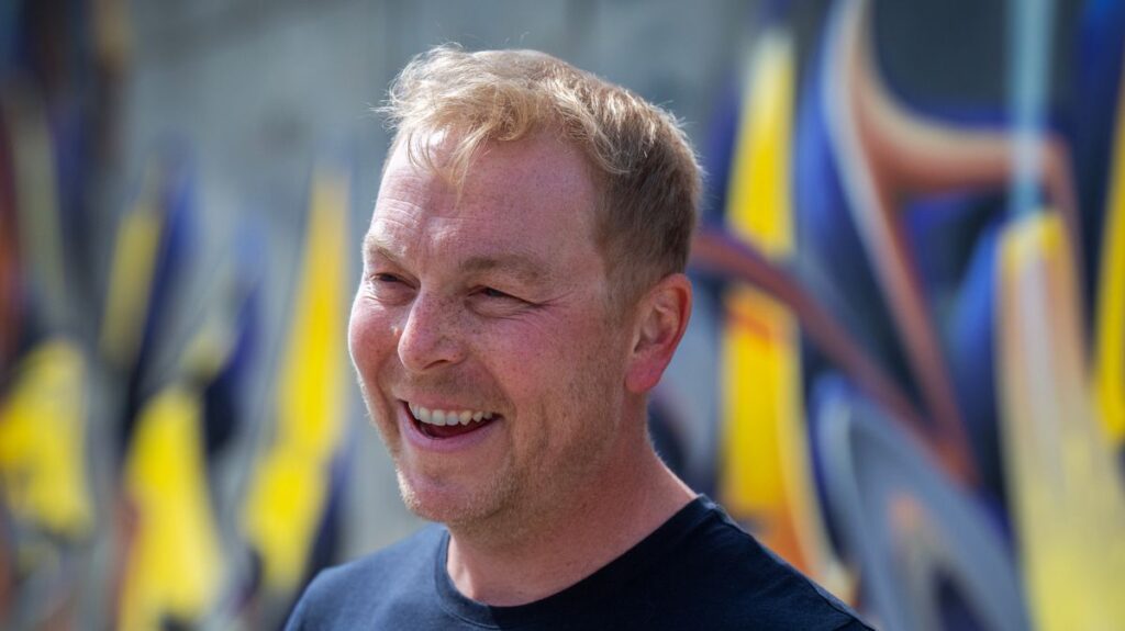 Sir Chris Hoy smiling while participating in a charity cycling event