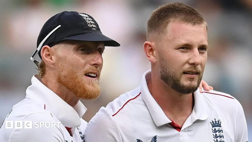 Ben Stokes and Gus Atkinson standing together in England cricket uniforms