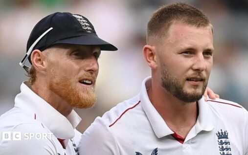 Ben Stokes and Gus Atkinson standing together in England cricket uniforms