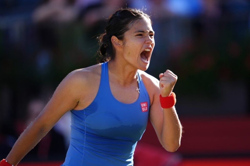 Emma Raducanu hitting a forehand on a grass court during the Queen's Championship