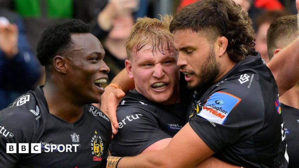 Exeter Chiefs players celebrating a try against Saracens during their crucial Premiership Rugby clash