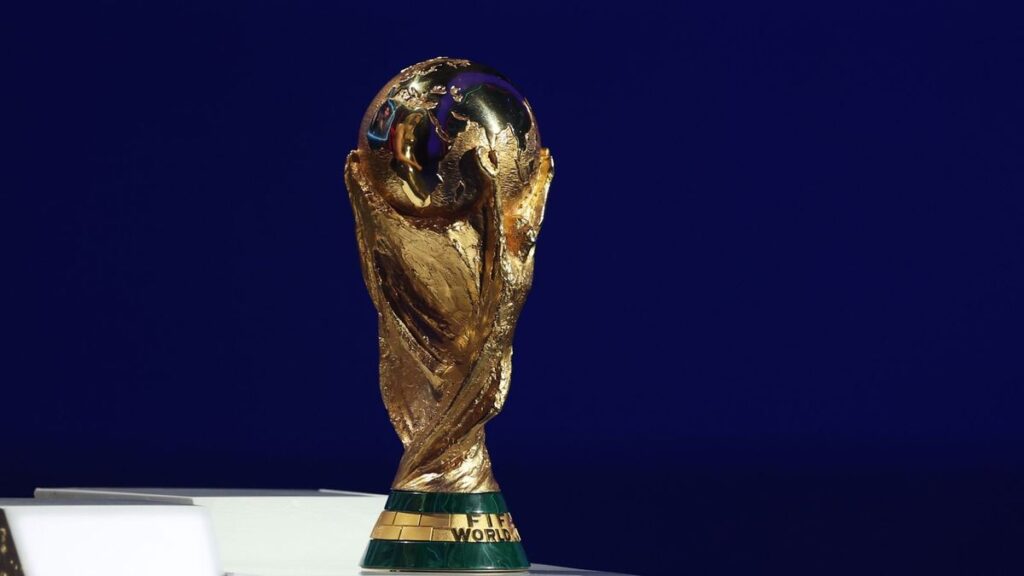The official World Cup 2026 tournament logo displayed prominently on a brightly lit stadium screen
