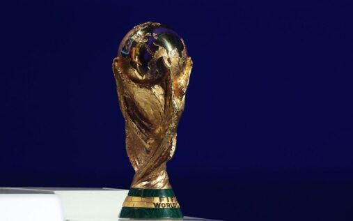 The official World Cup 2026 tournament logo displayed prominently on a brightly lit stadium screen