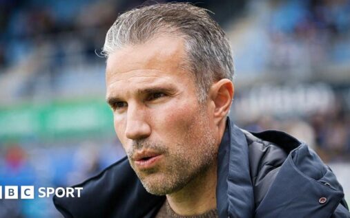 Robin van Persie looking disappointed on the touchline while managing Feyenoord
