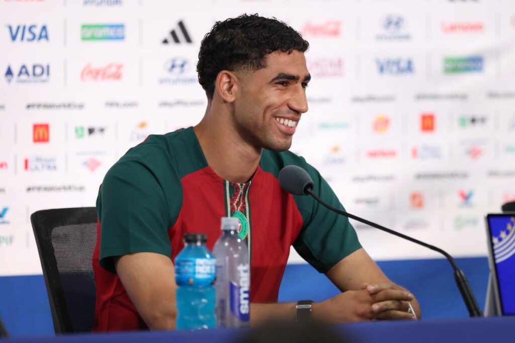 Achraf Hakimi and Vinicius Jr looking serious at a football match
