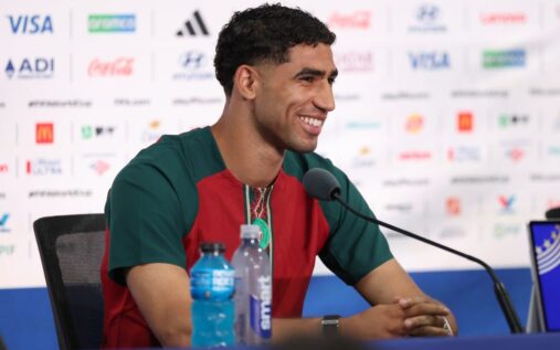 Achraf Hakimi and Vinicius Jr looking serious at a football match