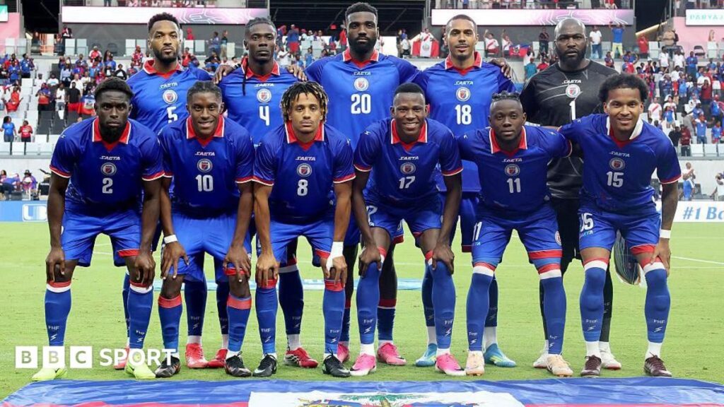 Haiti national football team players wearing their official match kit on the pitch
