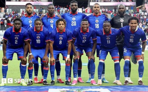 Haiti national football team players wearing their official match kit on the pitch