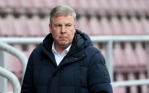 Former football manager Kenny Jackett standing on the touchline observing a match
