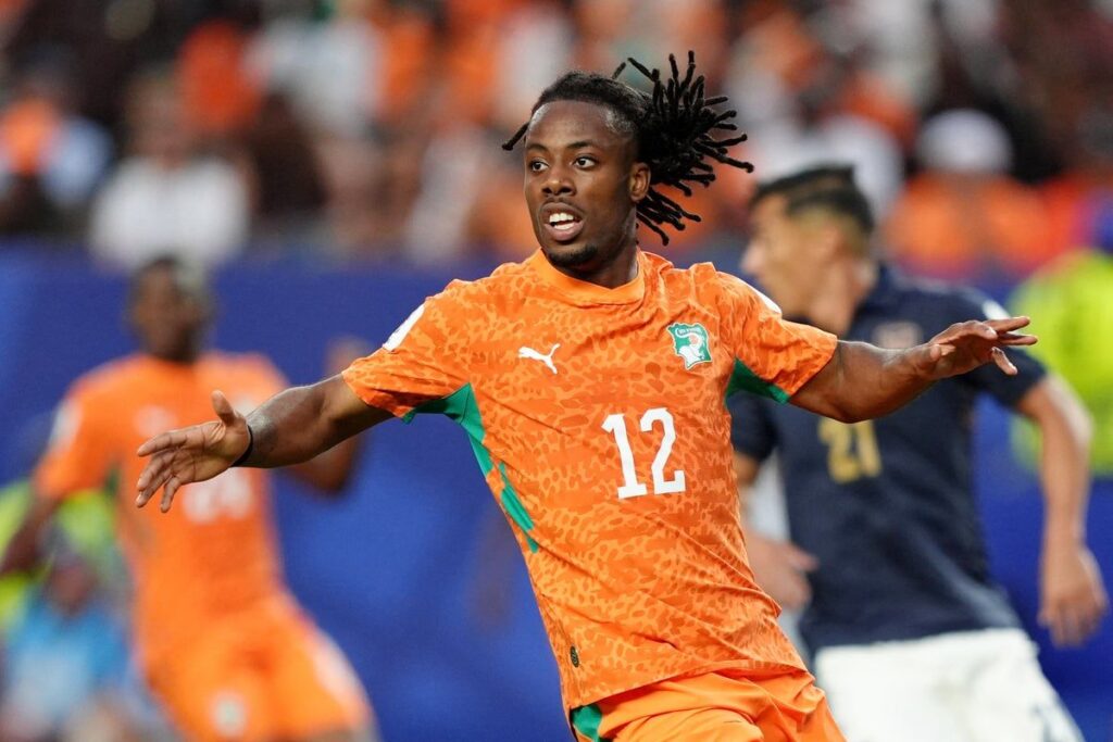Elye Wahi playing for Ivory Coast during a competitive international football match