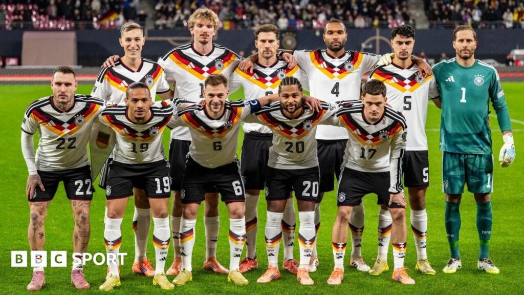 Joshua Kimmich and the Germany national team lining up on the pitch ahead of a World Cup match