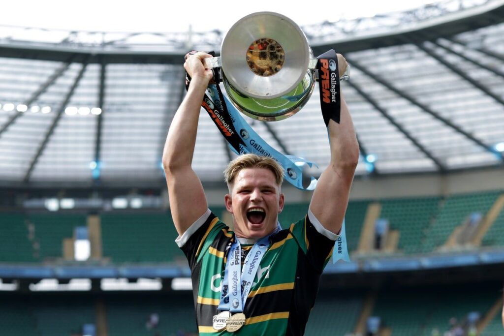 Henry Pollock celebrating with the Premiership trophy after Northampton Saints' final victory