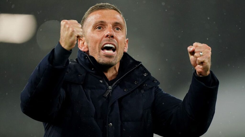 Gary O'Neil holding an Ipswich Town scarf at Portman Road after being announced as the club's new manager