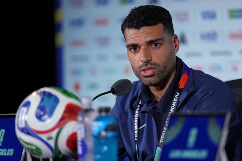 Iran captain Mehdi Taremi speaking seriously during a World Cup press conference