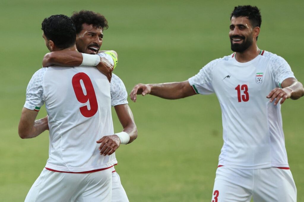 Iran national football team players line up on the pitch ahead of an international match