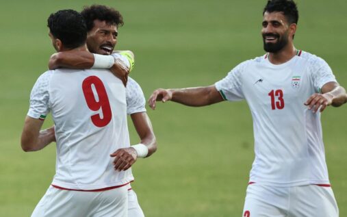 Iran national football team players line up on the pitch ahead of an international match