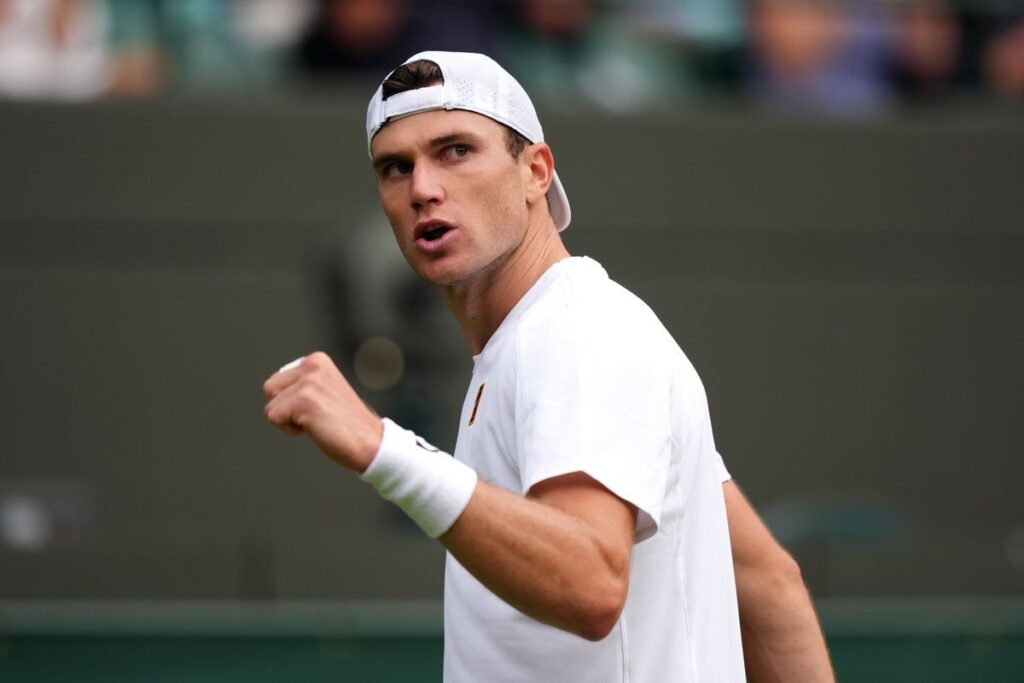 Jack Draper hitting a forehand on a grass tennis court