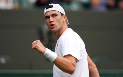 Jack Draper hitting a forehand on a grass tennis court