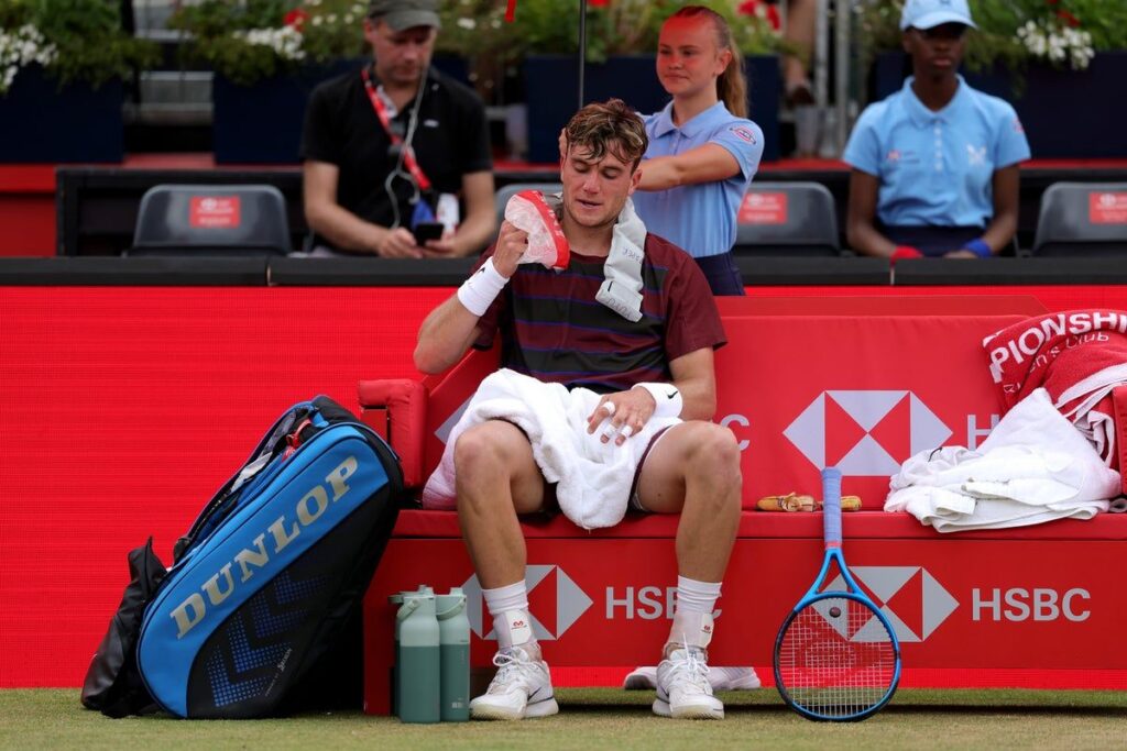 Jack Draper looking disappointed on a tennis court during a grass-court match