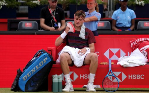 Jack Draper looking disappointed on a tennis court during a grass-court match
