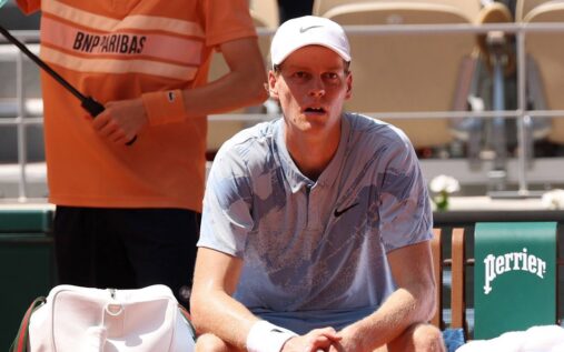 Jannik Sinner looking serious on a tennis court during a Grand Slam tournament