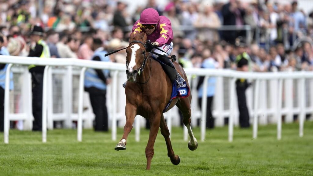 Thundering On and jockey Dylan Browne McMonagle crossing the finish line to win the Betfred Oaks at Epsom racecourse.