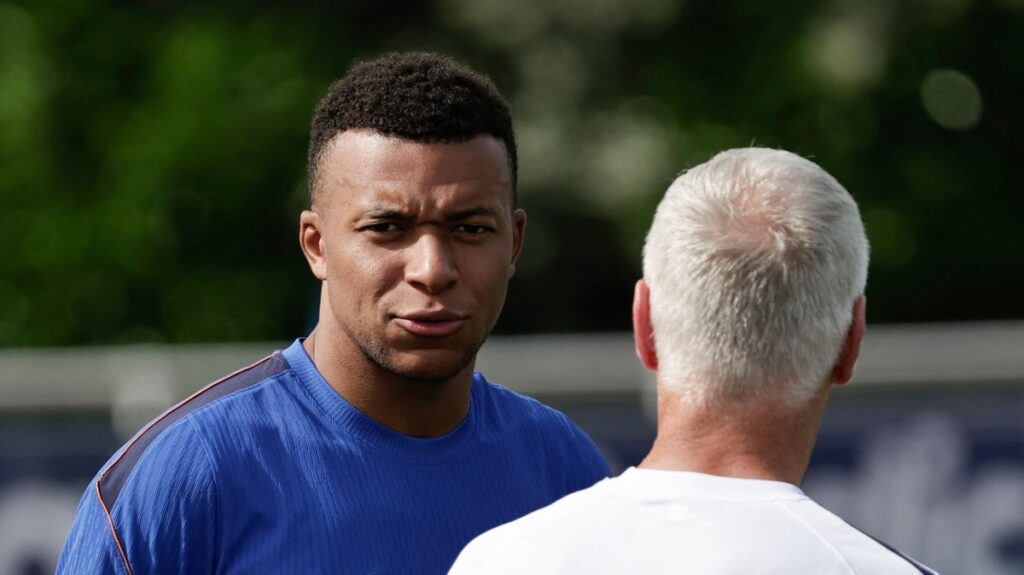 Kylian Mbappe speaking to the media in a Real Madrid kit