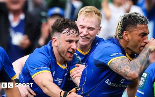 Leinster rugby players lifting the United Rugby Championship trophy while celebrating their victory over the Bulls