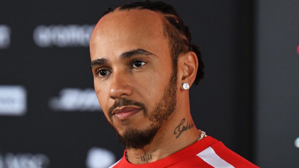 Lewis Hamilton in Ferrari team wear looking focused ahead of a Formula 1 Grand Prix