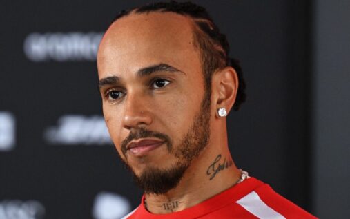 Lewis Hamilton in Ferrari team wear looking focused ahead of a Formula 1 Grand Prix