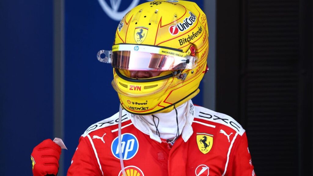 Lewis Hamilton celebrating in his red Ferrari race suit after winning the Formula 1 Grand Prix in Barcelona