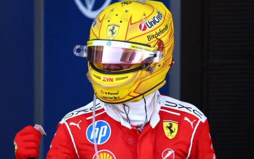Lewis Hamilton celebrating in his red Ferrari race suit after winning the Formula 1 Grand Prix in Barcelona