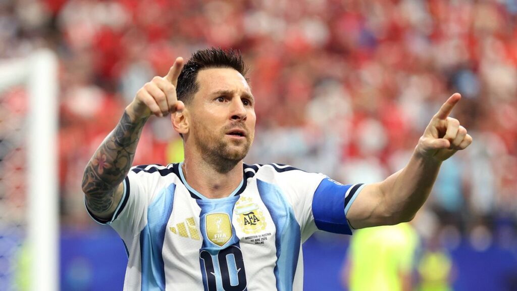 Lionel Messi wearing the Argentina captain's armband looking thoughtful on the pitch