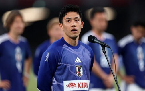 Wataru Endo wearing the Japan national team kit looking emotional on the pitch