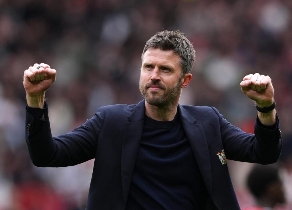 Michael Carrick standing on the touchline managing Manchester United during a match