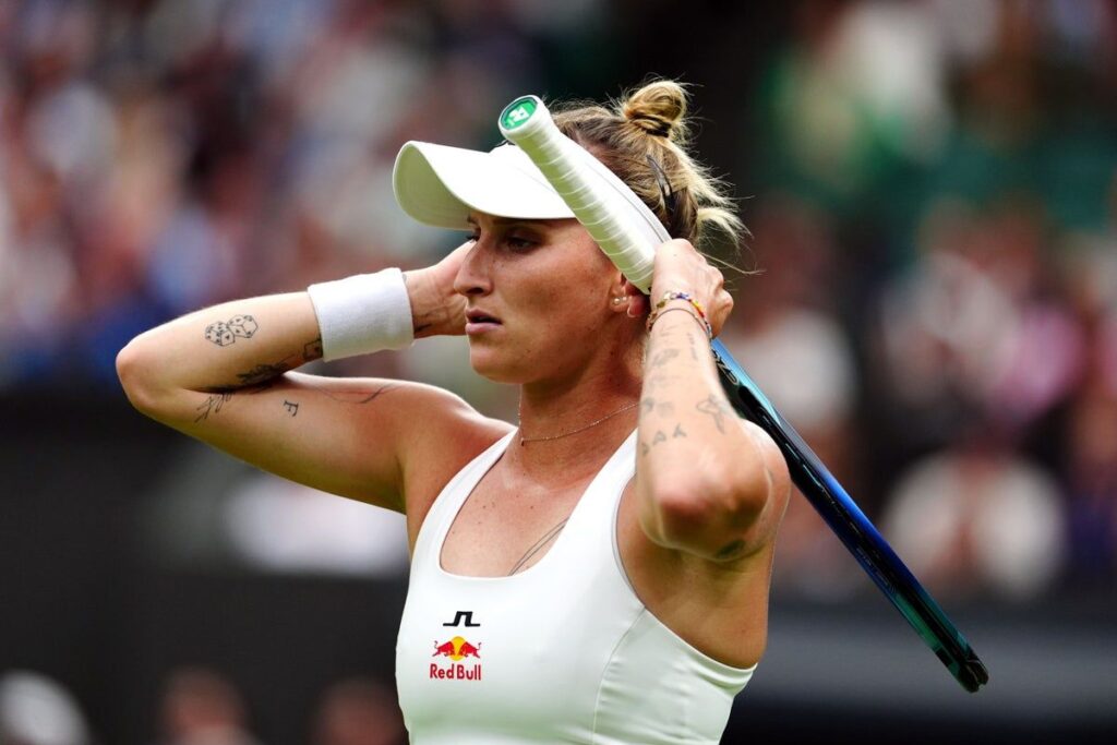 Marketa Vondrousova holding her tennis racket on the grass courts at Wimbledon
