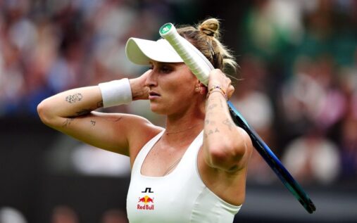 Marketa Vondrousova holding her tennis racket on the grass courts at Wimbledon