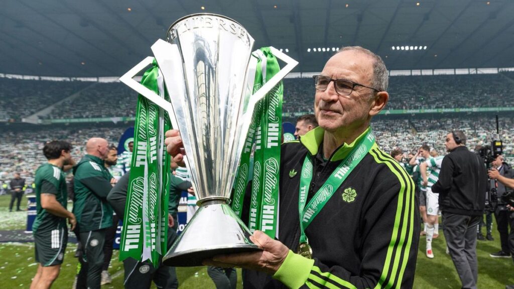 Martin O'Neill smiling while managing Celtic from the touchline