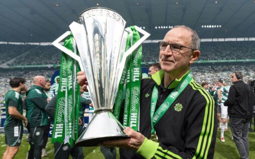 Martin O'Neill smiling while managing Celtic from the touchline