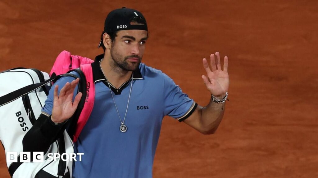 Matteo Berrettini sits disconsolate in his chair after retiring from his French Open quarter-final
