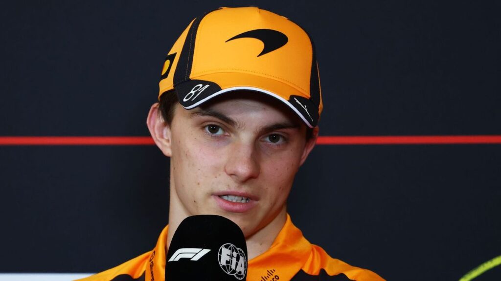 Oscar Piastri speaking to the media wearing McLaren team apparel