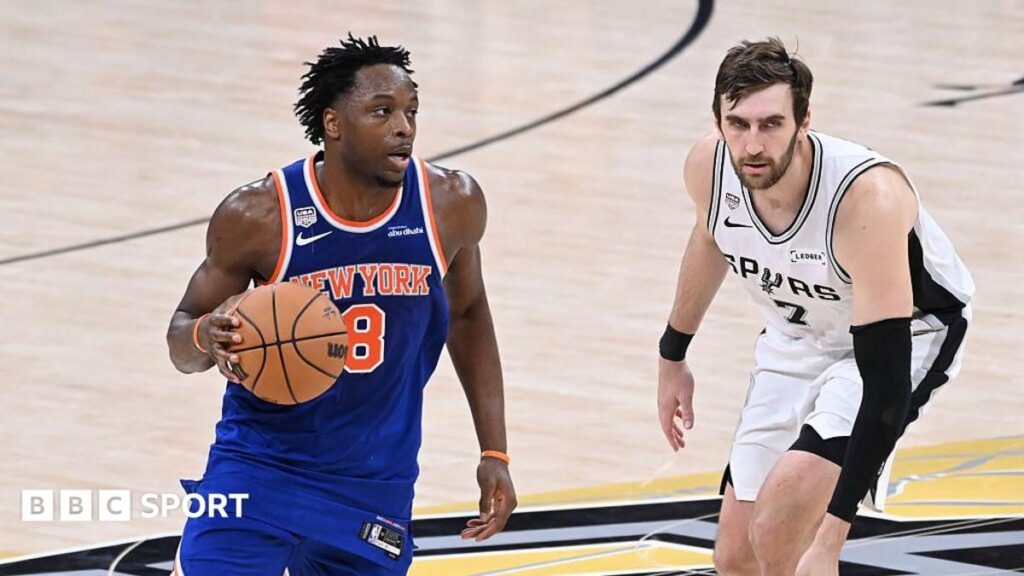 OG Anunoby celebrating on court in a New York Knicks jersey during the NBA Finals
