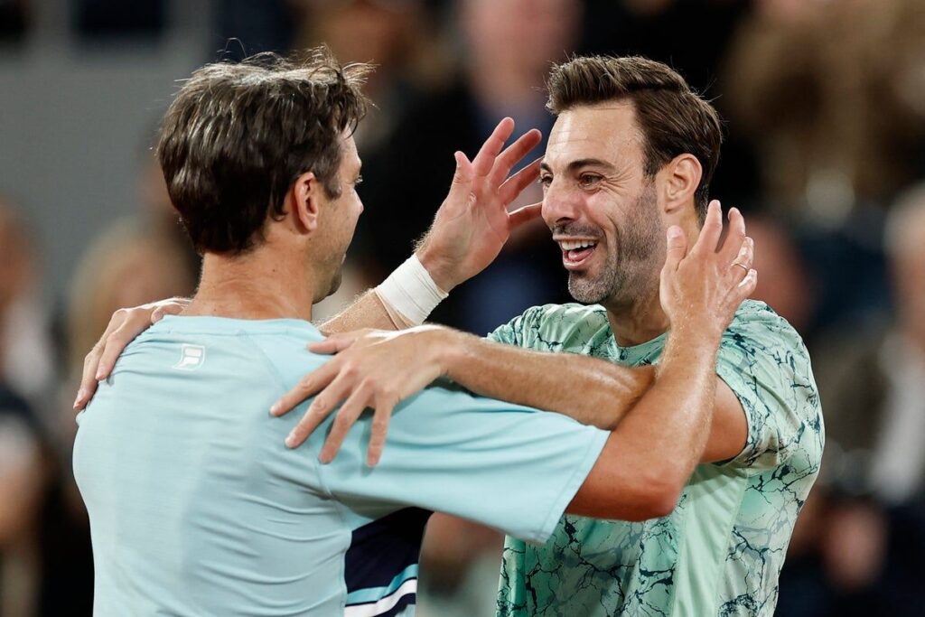 Henry Patten and Harri Heliovaara walking off the clay court after losing the French Open men's doubles final in Paris