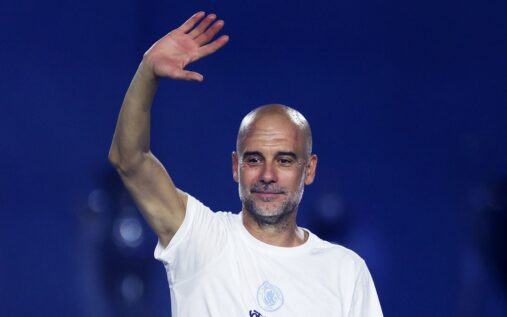 Pep Guardiola standing on the touchline gesturing during a match