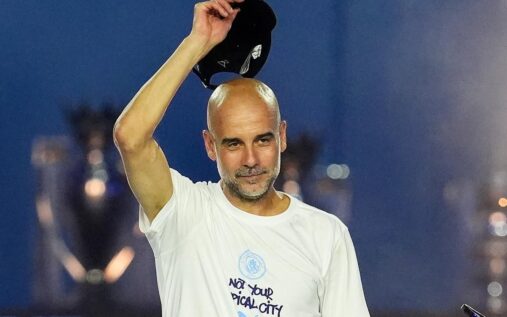 Pep Guardiola standing on the touchline looking thoughtful during a match