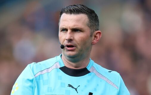 Premier League referee Michael Oliver looking closely at the pitch during a match