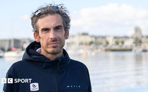 French sailor Charlie Dalin smiling aboard his racing yacht during the Vendee Globe
