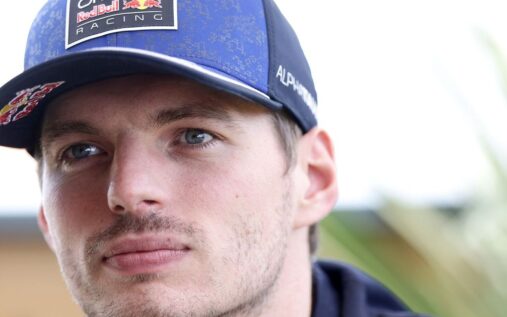 Max Verstappen wearing his Red Bull racing suit while speaking to the media in the Formula 1 paddock